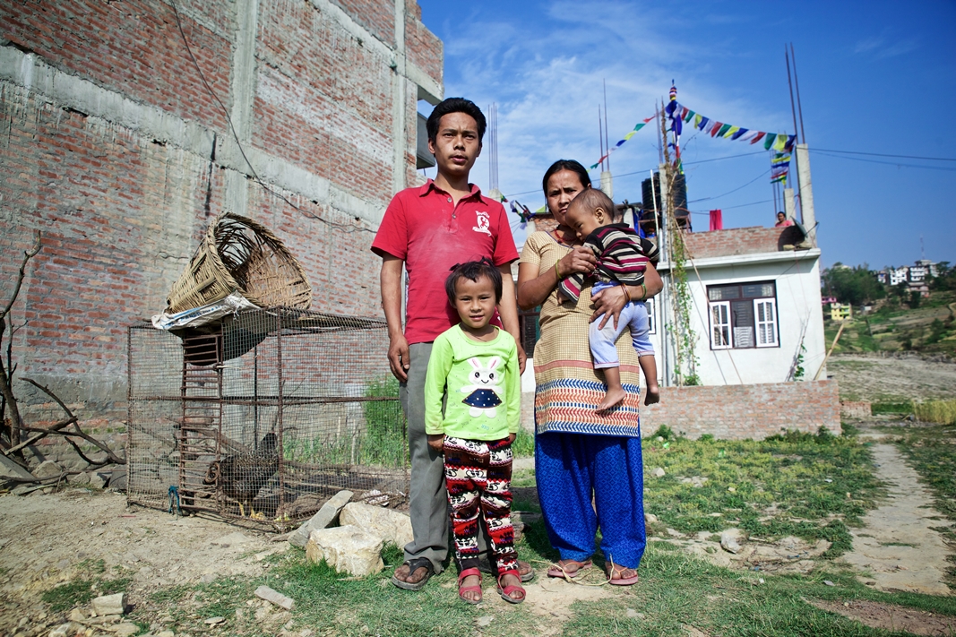 Rasmina along with her parents and her 15 month old brother, Ganesh Lama, outside her house in Banepa. Photo Credit: Mithila Jariwala