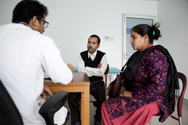 Yogendra and his wife Parvati consult a doctor during his follow up visit. Photo Credit: Mithila Jariwala