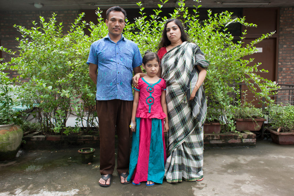 Nishita, 9, poses with her parents, Motiar and Rehana. Photo credit: Suvra Kanti Das
