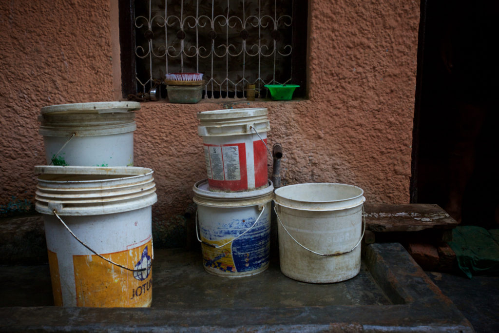Water is scarce in Yadav’s home village and buckets on the street in Jharsa hold many residents’ water supply, leaving it exposed to contamination from bacteria that causes typhoid and other diarrheal diseases. (Photo credit: Mithila Jariwala)