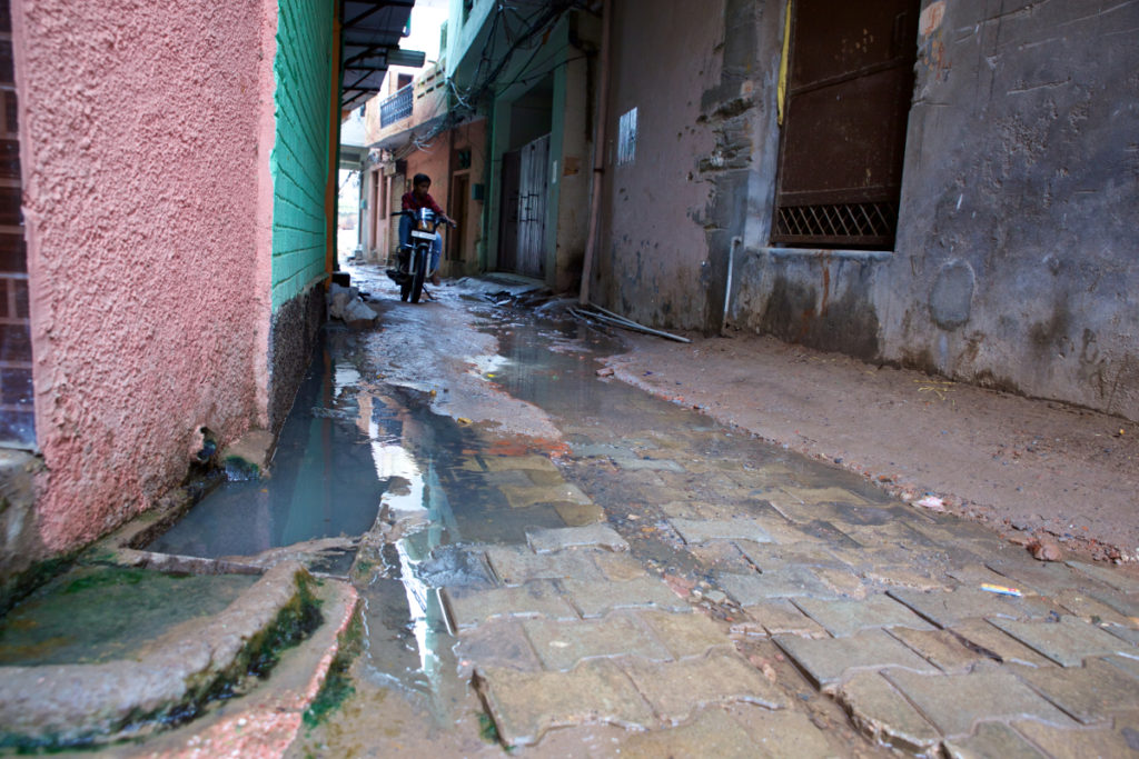 A street in the village of Jharsa contains sewage and dirty water, increasing the risk of typhoid for its inhabitants like Yadav. (Photo credit: Mithila Jariwala)