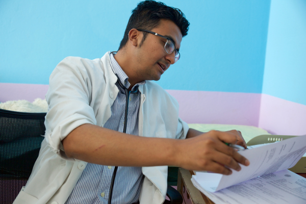 Dr. Shrestha reviews his patient Subigyan’s chart.