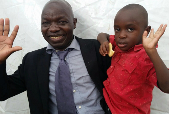 Four year old Golden Kondowe with his dad, Christopher, after receiving his vaccine.
