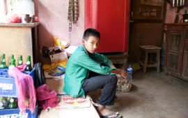 Eleven-year-old Ayush Lama sits in his home. He was the first in his family to get sick with typhoid.