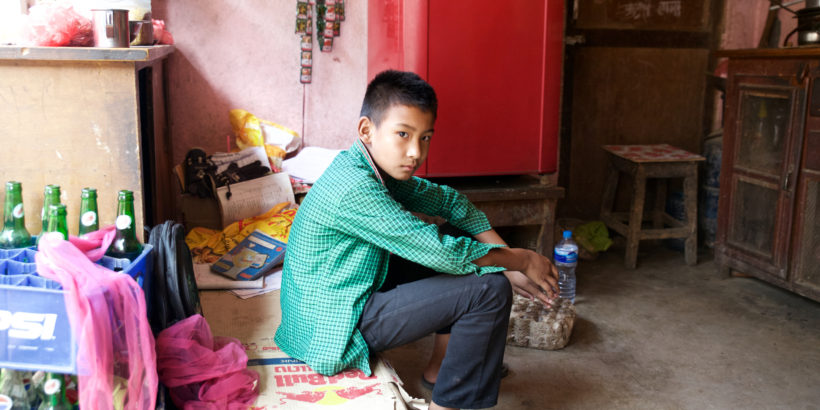 Eleven-year-old Ayush Lama sits in his home. He was the first in his family to get sick with typhoid.