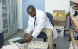 Pharmacist at Malawi Liverpool Wellcome Trust prepares typhoid conjugate vaccine for efficacy trial. Economic data in addition to efficacy data will help inform Malawi's strategy.