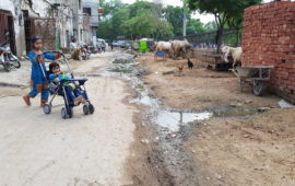 Children play in a street with an open drain in Pakistan. Photo: Raja Khalid Shabbir.