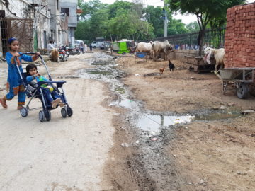 Children play in a street with an open drain in Pakistan. Photo: Raja Khalid Shabbir.