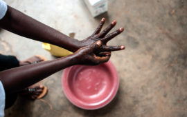 Health worker washes her hands