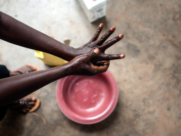 Health worker washes her hands