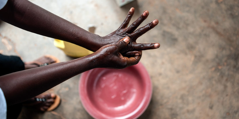 Health worker washes her hands