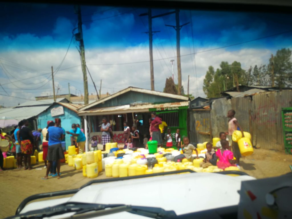 Residents of Mukuru gather water.