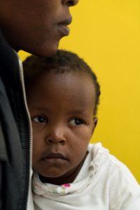 Angela Godfrey, age 26, holds her daughter Sara Kambua, age 5, at the health clinic in Mukuru, Kenya, February 5, 2018. 