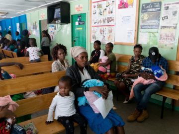 Angela Godfrey, age 26, and her daughter Sara Kambua, age 5, wait in the health clinic in Mukuru, Kenya, February 5, 2018.