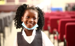 happy child smiles after receiving her typhoid vaccine