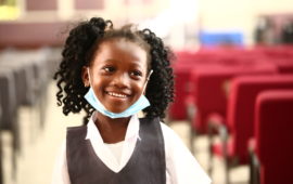 happy child smiles after receiving her typhoid vaccine