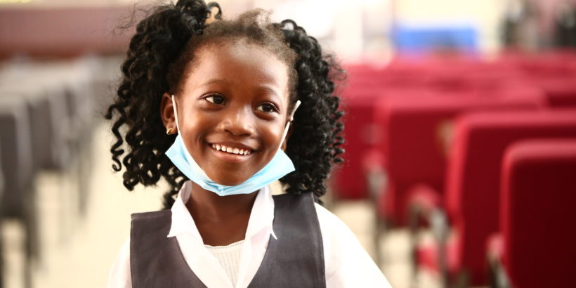 happy child smiles after receiving her typhoid vaccine