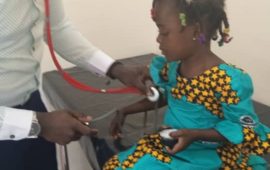 Doctor checks girl's heartrate before administering TCV in Ghana