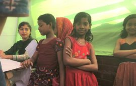 Girl in Bangladesh crosses her arms and looks at the camera