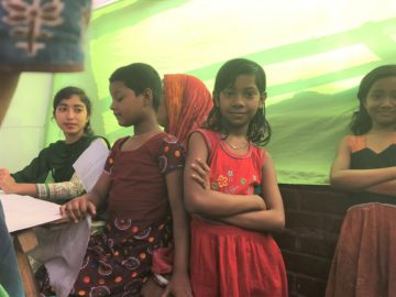 Girl in Bangladesh crosses her arms and looks at the camera