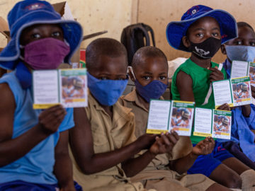 Group of children wait to get vaccinated with TCV