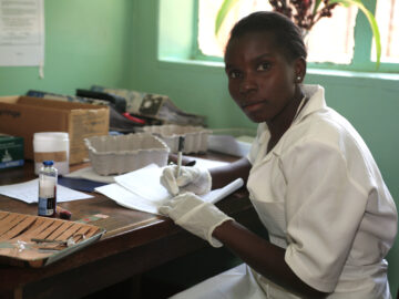 Nurse in Malawi works in lab. STRATAA
