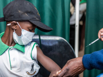 Child wearing mask receives typhoid conjugate vaccine, Zimbabwe