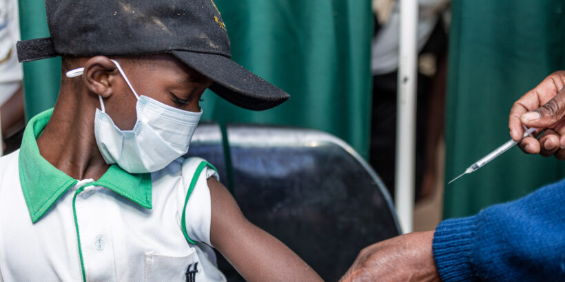 Child wearing mask receives typhoid conjugate vaccine, Zimbabwe