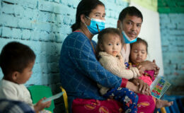 parents with their children as they are vaccinated with TCV