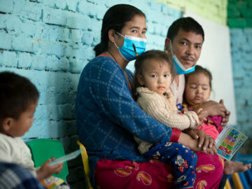 parents with their children as they are vaccinated with TCV