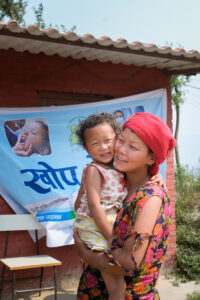 A mother embraces her child who was vaccinated with TCV during Nepal’s introduction campaign. 