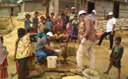 icddr,b team tests water supplies in Rohingya refugee camp, surrounded by crowd