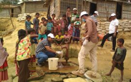 icddr,b team tests water supplies in Rohingya refugee camp, surrounded by crowd