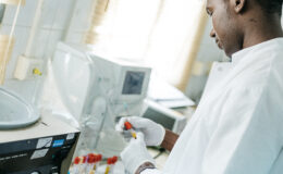 A laboratory worker performs diagnostic tests