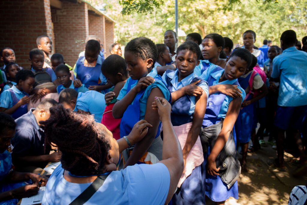 Pupils at Mitole Primary School in Malawi receive the typhoid conjugate vaccine during the country's integrated vaccination campaign in 2023.