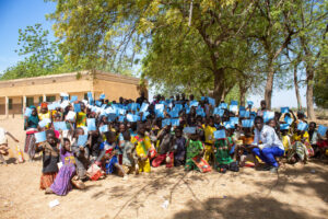 Children in Burkina Faso hold up their vaccination cards after receiving TCV. 