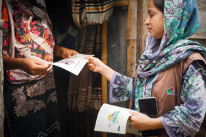 Immunization campaign workers share educational materials to raise awareness during Bangladesh’s TCV introduction campaign. 