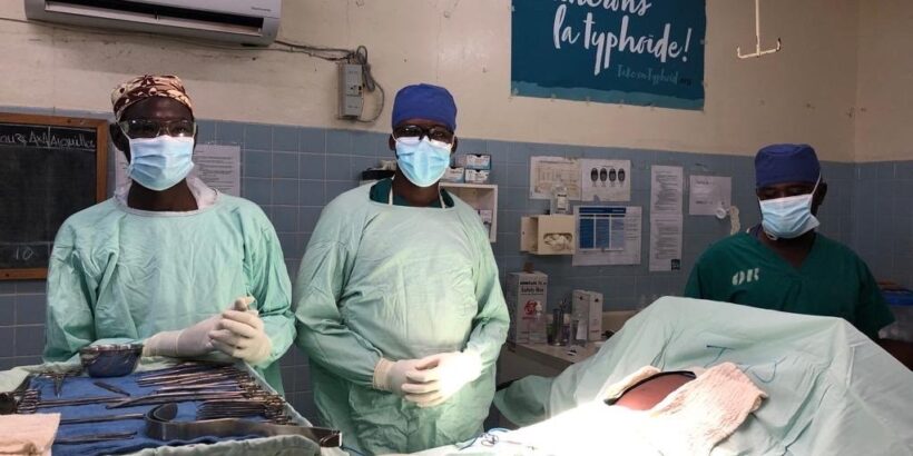 Three surgeons at the hospital in Galmi, Niger, stand in the operating room ready to treat patients with typhoid intestinal perforation.