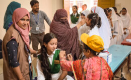 A vaccinator administers TCV during Bangladesh’s introduction campaign in fall 2025.