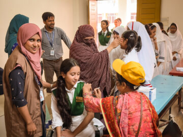 A vaccinator administers TCV during Bangladesh’s introduction campaign in fall 2025.