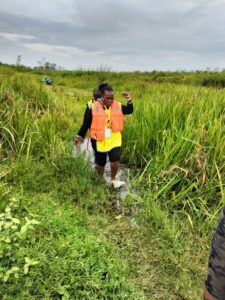 Women vaccinators navigate muddy terrain to reach children with typhoid conjugate vaccines in Kenya.