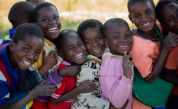CHildren smile as they queue up for the integrated vaccination campaign in Phalombe, Malawi.