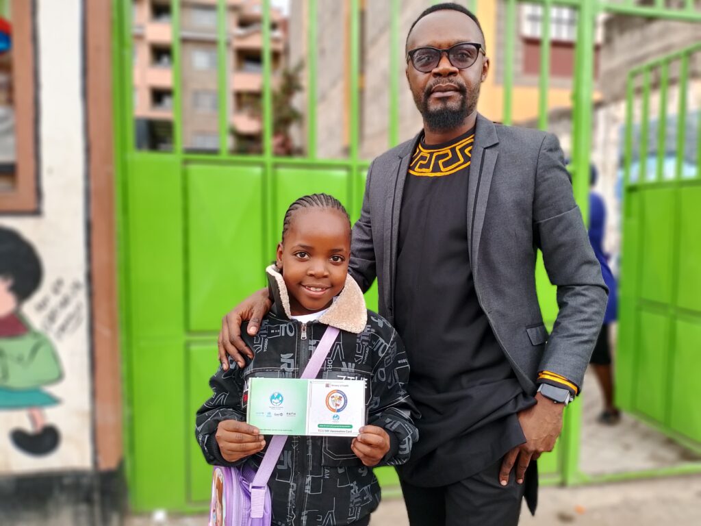 Vaccines work, but it takes courage and commitment - exemplified by nine-year-old Joy, who received TCV during Kenya's TCV introduction campaign, and her father, Wallace.