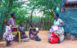 Lupeyo, a father from Kakuma, Turkana, Kenya, sits with a community health promoter. Lupeyo is one of many fathers in Kenya who recognize that vaccines work.