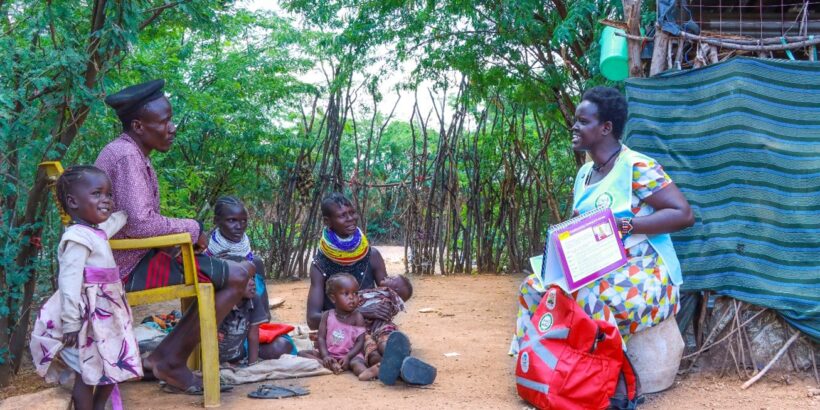 Lupeyo, a father from Kakuma, Turkana, Kenya, sits with a community health promoter. Lupeyo is one of many fathers in Kenya who recognize that vaccines work.