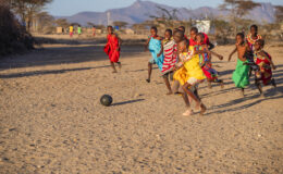 African children from Samburu tribe playing football in the village, Kenya, East Africa. Samburu tribe is north-central Kenya, and they are related to the Maasai.