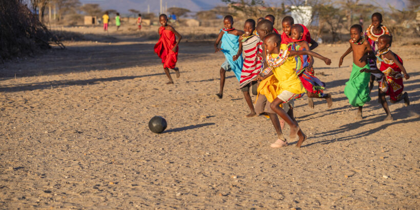 African children from Samburu tribe playing football in the village, Kenya, East Africa. Samburu tribe is north-central Kenya, and they are related to the Maasai.