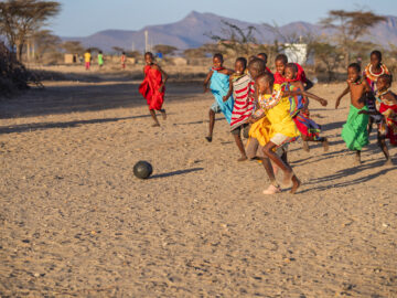 African children from Samburu tribe playing football in the village, Kenya, East Africa. Samburu tribe is north-central Kenya, and they are related to the Maasai.
