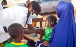 A health worker delivers TCV to a child during Burkina Faso's TCV introduction campaign. A new study examines the costs of the campaign.