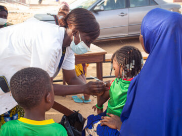 A health worker delivers TCV to a child during Burkina Faso's TCV introduction campaign. A new study examines the costs of the campaign.